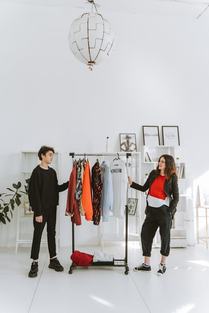 Mother and teenage son discussing fashion choices in a bright, modern room.